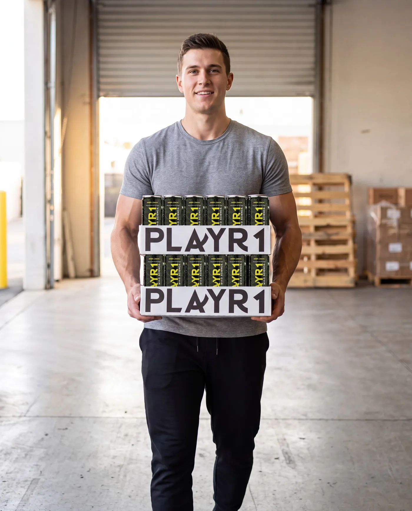 Man carrying two PLAYR1 cases in a warehouse